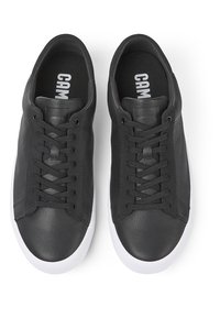 Mustad nahast tennisetossud, millel on sile tekstuur, ümar nina, paeltega kinnitamine ja valge tald. Tald on trükitud "CAM."