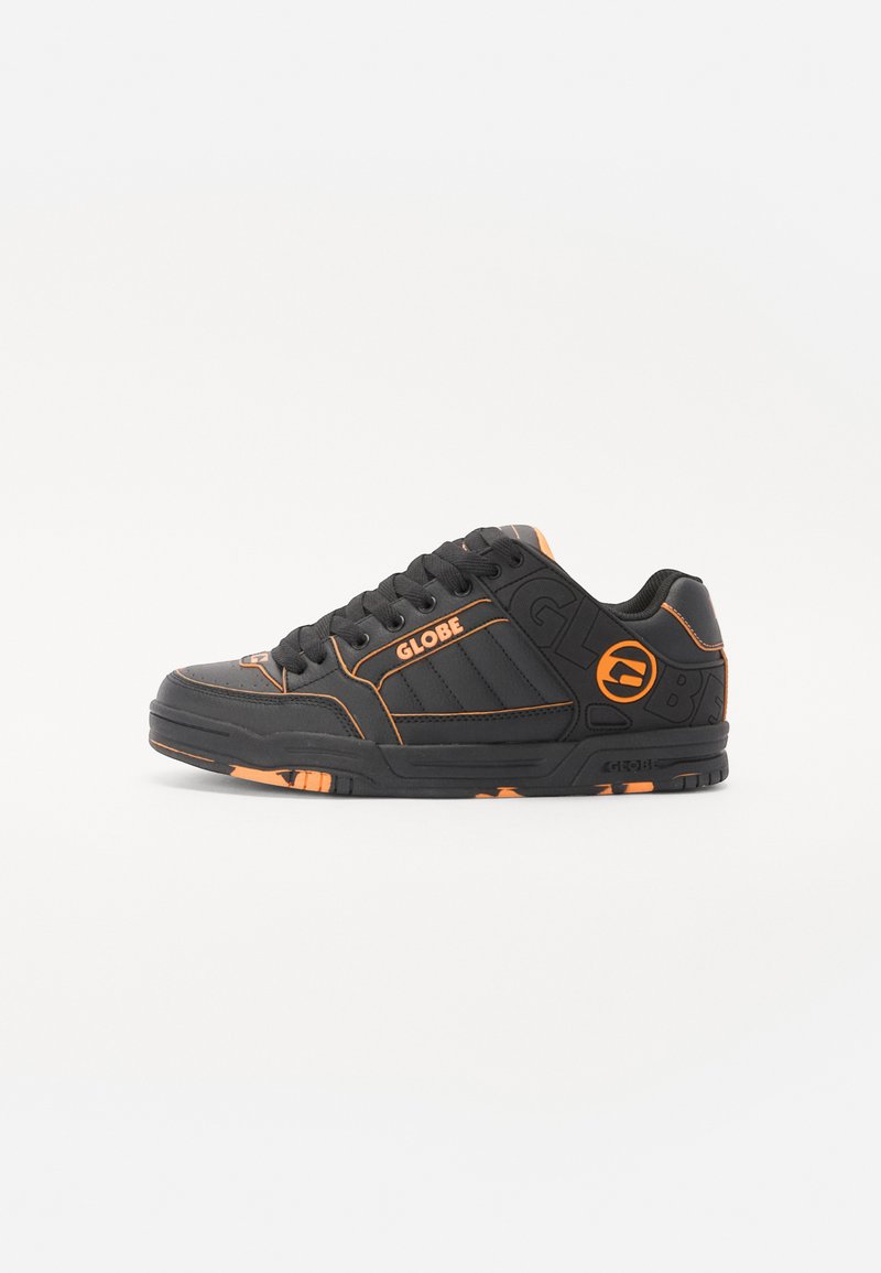 Black skate shoes featuring orange accents, textured synthetic material, lace-up design, and rubber soles with grip detail.