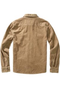 Chemise beige en velours côtelé à manches longues avec poignets boutonnés, col ouvert et texture côtelée verticale visible, vue de dos.