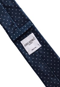 Marinblå slips med en texturerad design, prydd med vita prickar. Etiketten säger "John Henric, Tillverkad i Italien." Slät och elegant tyg.