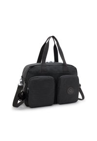 Black synthetic bag featuring dual front pockets, a round logo patch, and detachable shoulder strap with a furry accent charm.