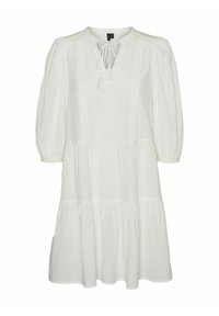 Robe blanche à volants avec une coupe ample, dotée d'un col rond, d'un détail à nouer et de manches ballons. Fabriquée en tissu léger.