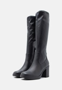 Black knee-high boots made of smooth leather, featuring a side zipper, rounded toe, and a chunky block heel.