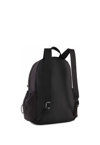 Sac à dos rembourré noir avec bretelles réglables, texture lisse, poche latérale et forme arrondie. Design minimaliste sans ferrures visibles.