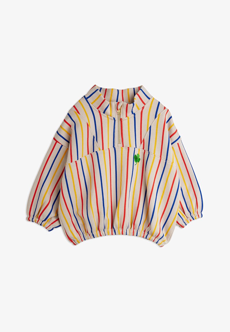 Langærmet cremefarvet pullover med røde, blå og gule lodrette striber, halv lynlås-krave, elastiske manchetter og kant, samt en lille grøn kløverdetalje.