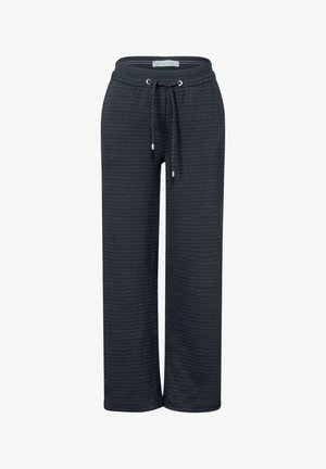 Mørkegrå joggingbukser med mønstret tekstur, elastisk talje og justerbar snor. Har flade sømme og vide ben.