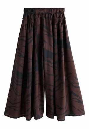 Vide ben culottes i en brun stof med et mørkt, abstrakt tigermønster. Elastisk talje, flagrende form og blød tekstur.