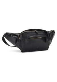 Banane en cuir noir avec fermetures éclair dorées, poche avant et sangle ajustable, marquée "EXPATRIÉ" sur le panneau avant.