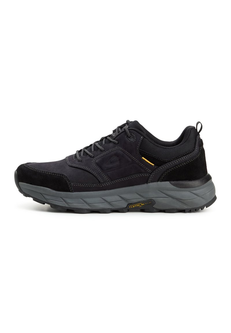 Black athletic shoes with a suede and mesh upper, grey midsole, textured rubber sole, and yellow accent detail. Lightweight and durable design.