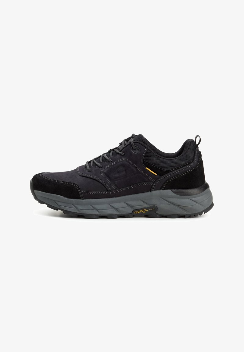 Black athletic shoes with a suede and mesh upper, grey midsole, textured rubber sole, and yellow accent detail. Lightweight and durable design.
