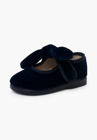 Navy fluwelen schoen met een ronde neus, grote strikdetail bovenop en een zwarte rubberen zool. Zachte binnenvoering voor comfort.