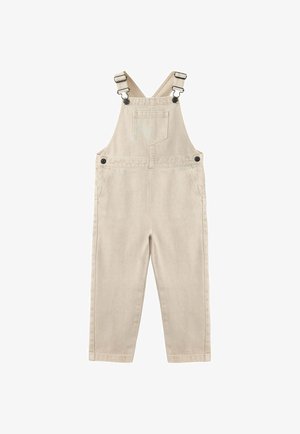 Salopette beige en coton avec bretelles ajustables, poche poitrine à l'avant, boutons latéraux et deux poches latérales.