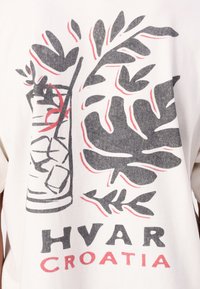 White cotton t-shirt featuring a graphic design of a beverage with ice and tropical leaves. Text reads "HVAR" in bold black and "CROATIA" in red.