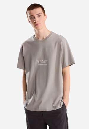 The North Face, U ZUMU 2.0 RELAXED SS TEE. UNISEX - T-shirt imprimé - stone slab