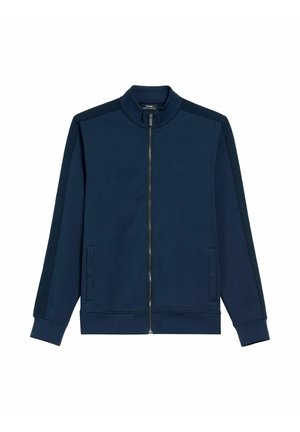 Granatowa kurtka zapinana na zamek z stójką, prążkowanymi bocznymi panelami i dwoma przednimi kieszeniami. Wykonana z miękkiego, teksturowanego materiału.