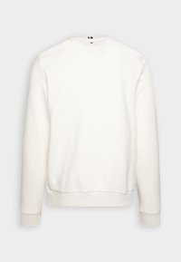 Felpa bianca a maniche lunghe con scollo a V, polsini e orlo a costine. Tessuto morbido con design minimalista e un piccolo logo sul collo.