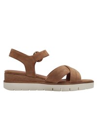 Brown suede sandal with crisscross straps, a padded footbed, adjustable ankle strap, and a white platform sole for stability.