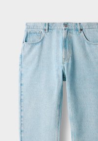 Light blue denim jeans with a straight-leg design, featuring two front pockets, belt loops, and a button closure. Faded texture.