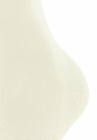 Calzino alla caviglia beige chiaro realizzato in morbido materiale a coste con una texture liscia e una forma aderente, adatto per un abbigliamento casual.