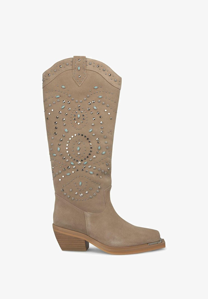 Beżowe zamszowe buty w stylu western z ozdobnymi ćwiekami i turkusowymi akcentami, spiczasty nos, skośny obcas i lekko falbaniasty brzeg.