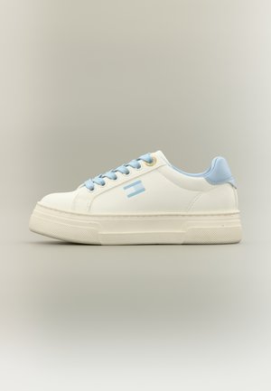 White sneaker with light blue accents, rounded toe, textured rubber sole, flat laces, and small logo detail on the side.
