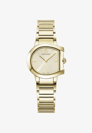 Ura iz zlatega kovine z ovalnim ohišjem, gladkim srebrnim številčnico in minimalističnimi oznakami ur; zapestnica v povezani izvedbi s poliranim zaključkom.