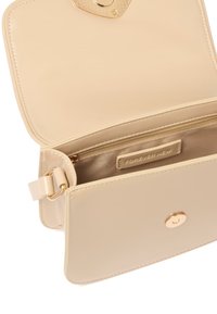 Beige faux leather handbag with a smooth texture, gold hardware, magnetic snap closure, and an interior zip pocket.