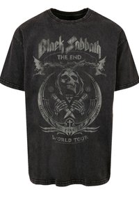 Black cotton t-shirt featuring a gray graphic print with skull, bat, and text design. Round neck and short sleeves, with a faded appearance.