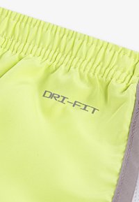 Neon yellow shorts with an elastic waistband, featuring a gray accent and “DRI-FIT” printed in gray near the waistband. Smooth texture.