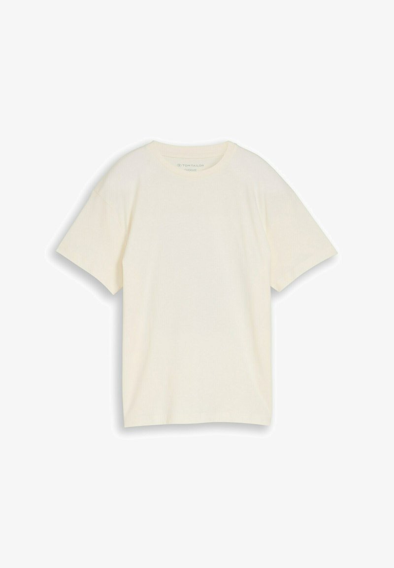 T-shirt basique surdimensionné à manches courtes avec col rond, de couleur beige clair, présenté à plat sur un fond blanc.