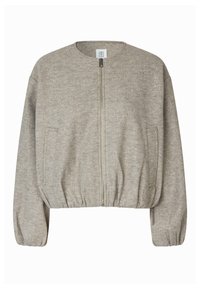 Veste beige à fermeture éclair avec encolure ronde, manches longues, poignets et ourlet élastiqués, et deux poches latérales.