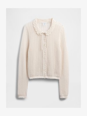 Cardigan en tricot crème avec un col festonné, fermeture à nouer à l'avant et motif texturé. Présente des poignets et un ourlet côtelés.