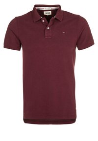 Burgundin värinen puuvillapolo, jossa on klassinen kaulus, kahden napin lista ja pieni logo rinnassa. Lyhyet hihat.