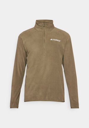 Καφέ φούτερ από φλις με μισό φερμουάρ στον γιακά, που διαθέτει το λευκό λογότυπο "TERREX" στην άνω αριστερή πλευρά. Μαλακή υφή και μακριά μανίκια.