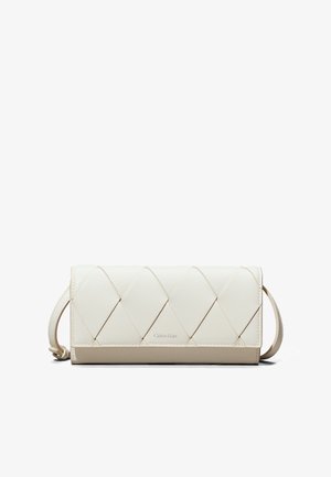Quilted cream leather wallet with a fold-over design, featuring a beige base and a discrete Calvin Klein logo. Includes a wrist strap.