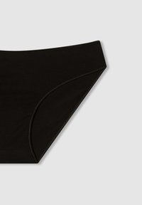 Mutande nere realizzate in un tessuto liscio e elastico, con una vita media e un design senza cuciture lungo i bordi per garantire comfort.