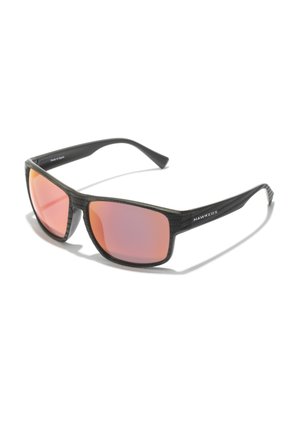 Schwarze Sonnenbrille mit strukturiertem Rahmen, orange getönten Gläsern und einem eleganten Design. Logo an der Seite mit "Hergestellt in Spanien."