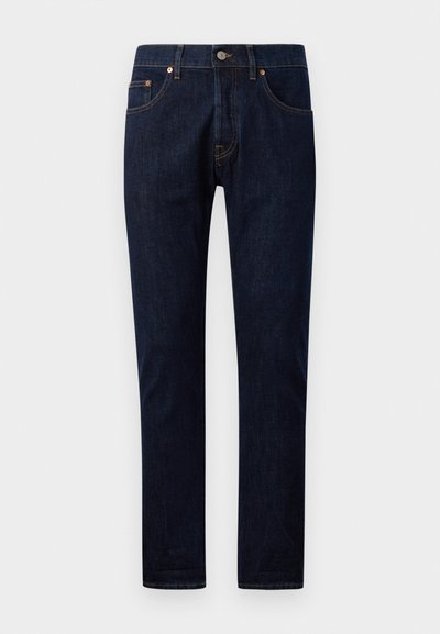 Jeans de mezclilla azul oscuro con corte slim, que cuentan con cinco bolsillos, remaches de cobre y costuras en contraste a lo largo de las costuras. Textura suave.