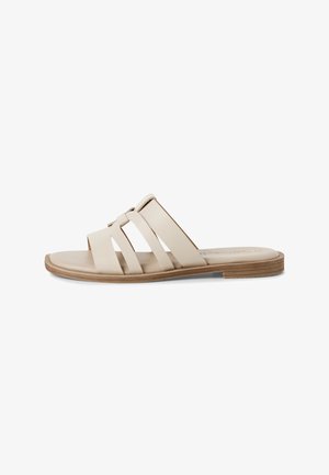 Beige slide sandal with three wide straps. Material appears smooth, with a flat, light brown sole and subtle stitching details.
