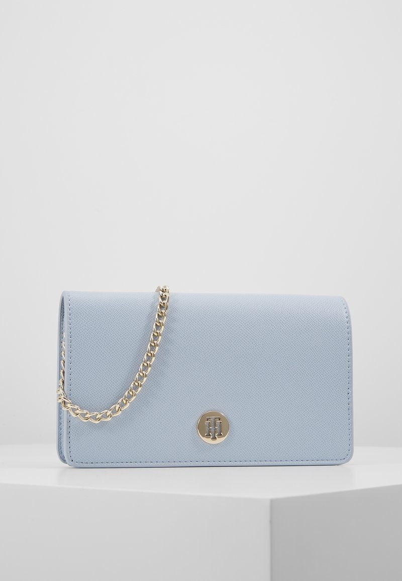 Jasnoniebieska torebka ze skóry syntetycznej o teksturowanym wykończeniu, złoty łańcuszek na pasku oraz okrągłe logo z przodu.