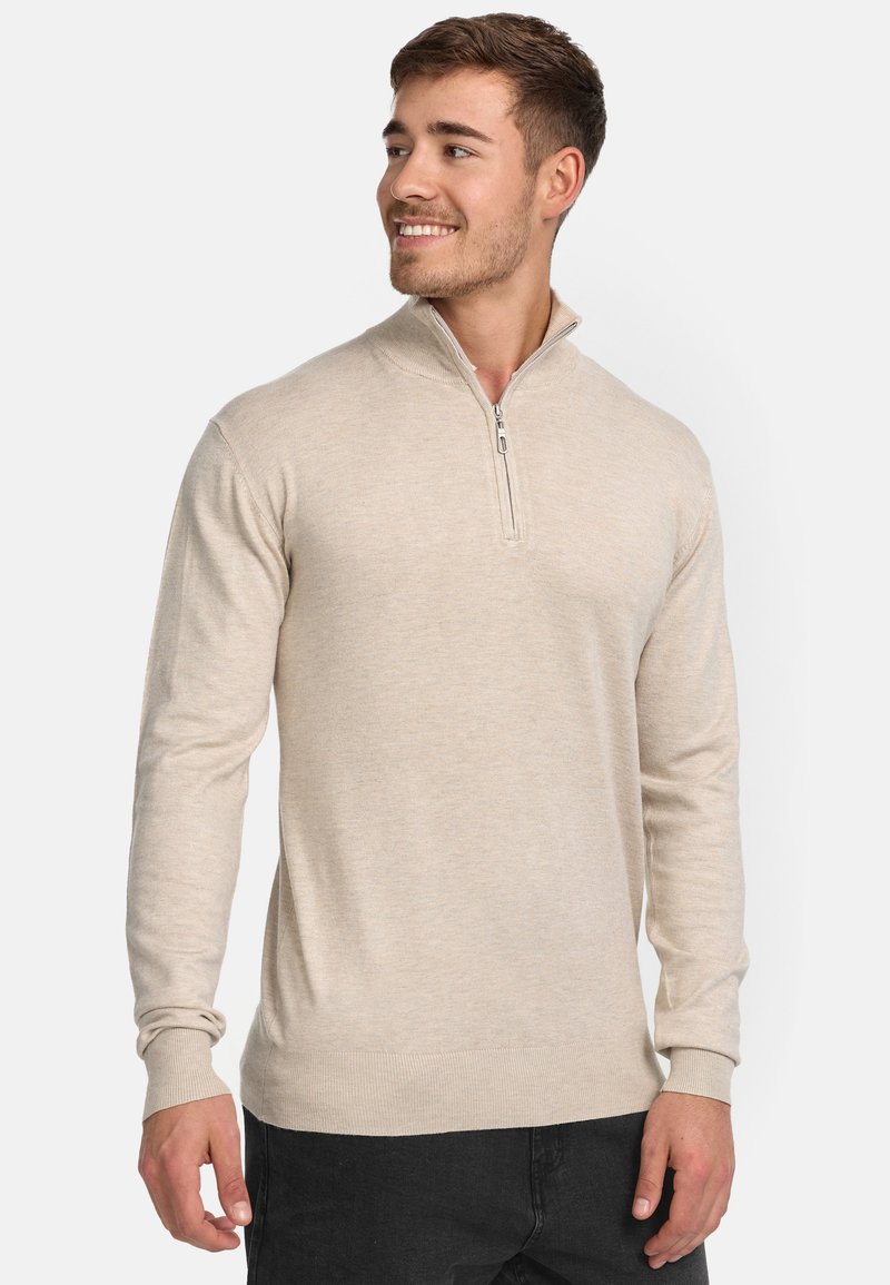 Helle beige Zip-up Sweatjacke mit langen Ärmeln, gerippten Bündchen und Saum. Weicher Stoff, taillierte Silhouette, minimalistisches Design.