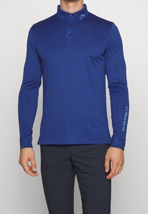 Blauw langemouw poloshirt met een kraag, drie knopen en een logodetail op de kraag en mouw. Glad, lichtgewicht stof.