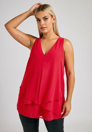 Red sleeveless top with a V-neckline, layered design, and lightweight fabric. Features a flowing silhouette and smooth texture.