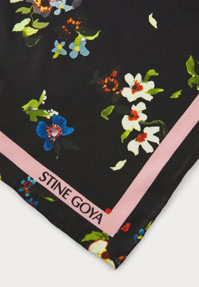 Black floral scarf featuring colorful flowers in blue, white, and red. A pink border with "STINE GOYA" printed along one edge. Silky texture.