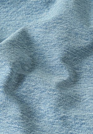 Light blue denim fabric with visible diagonal weave texture and soft folds creating shadows and highlights.