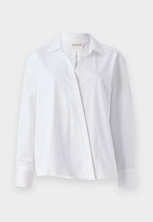 White long-sleeve shirt made of cotton with a pointed collar and a button-front closure. Features a relaxed fit and folded cuffs.