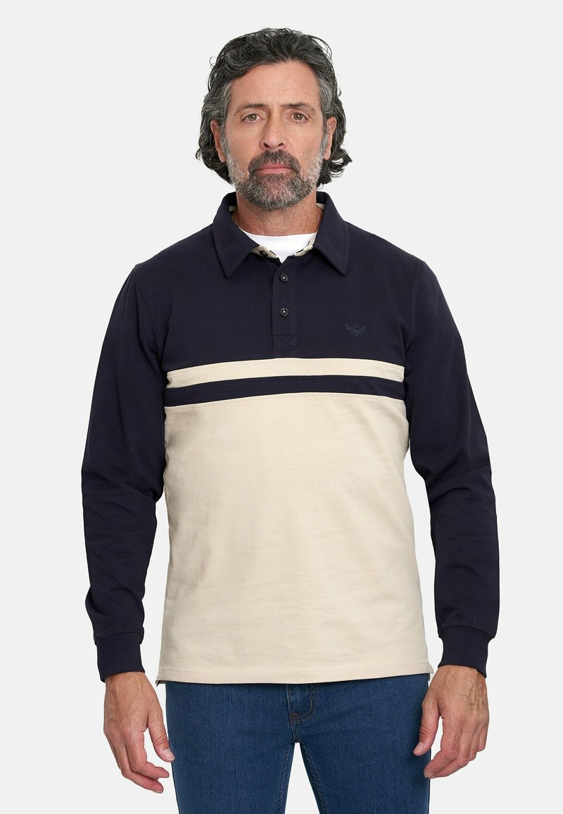 Camisa polo de manga larga con la parte superior en azul marino y la parte inferior en crema, con una franja horizontal azul marino en el pecho y un cuello con botones.