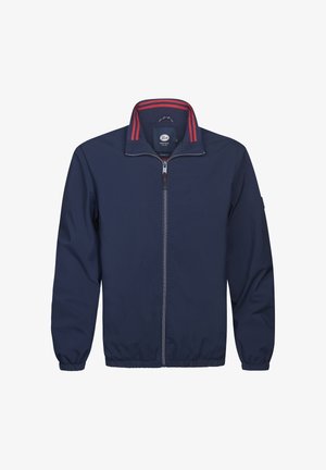 Jachetă bleumarin cu fermoar, guler cu dungi roșii, manșete elastice și textură netedă. Are etichetă cu logo în interiorul gulerului.
