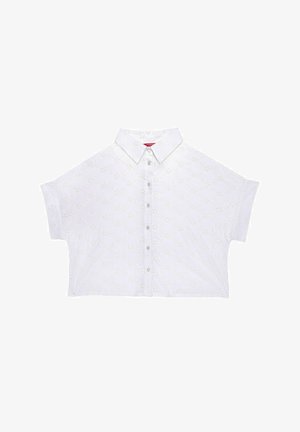 Cămașă albă scurtă, cu guler ascuțit, având broderie florală și un închidere cu nasturi. Mâneci scurte cu un croi lejer.