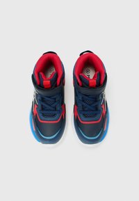Pair of blue and red children's athletic shoes with laces and Velcro straps, viewed from above on a white background.
